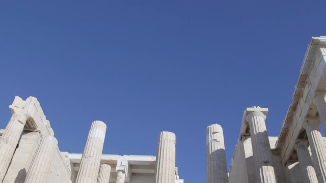 Beautiful blue sky over the ruins of the entrance of the Parthenon, at the Acropolis, Athens, Greece.