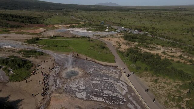 Aerial Cinematic footage of the Impressive Icelands Geysir Geisir in the Golden Circule, the geothermal activity and a attraction for tourists in Iceland	