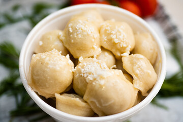 Cooked dumplings with cheese in a deep bowl
