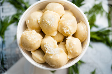 Cooked dumplings with cheese in a deep bowl