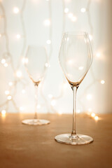 Two empty flute glasses for champagne or sparkling wine in a Christmas or New Year atmosphere, bokeh lights in the background