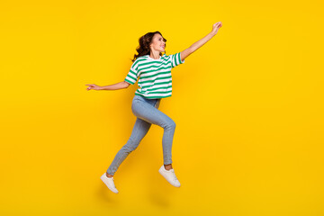 Fototapeta na wymiar Full size profile side photo of youth lady run walk try to catch look empty space isolated over yellow color background
