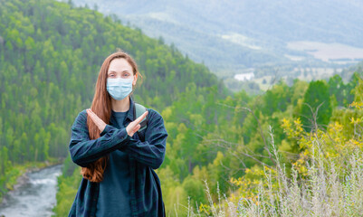 Young woman wearing face mask during coronavirus and flu outbreak showing stop gesture at hike....