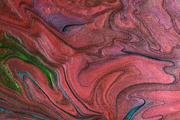 Beautiful shimmer stains of liquid nail polish.Red,green and blue colors.Stripy paint texture.Nail lacquer flow background in fluid art technique.Minimalism concept.Copy space,horizontal photography.