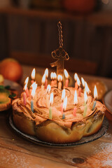 closeup birthday apple pie with burning candles and candle number one. marshmallows, gingerbread, apple pie, charlotte. healthy homemade sweets and fruits are on a wooden table. High quality photo