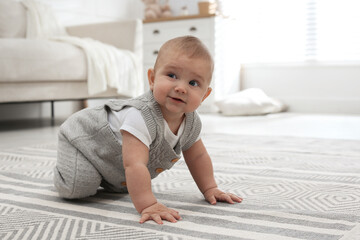 Cute baby crawling on floor at home