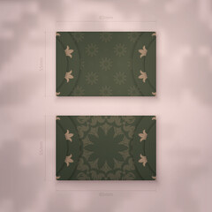 Presentable business card in green color with greek brown pattern for your business.