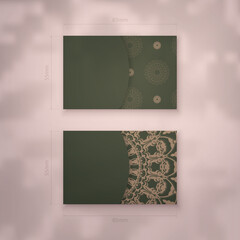 Presentable business card in green color with luxurious brown ornament for your contacts.