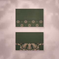 Presentable business card in green color with vintage brown ornament for your personality.