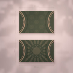 Presentable business card in green color with vintage brown pattern for your business.