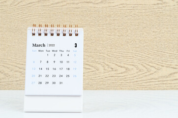 March 2022 desk calendar on the table.