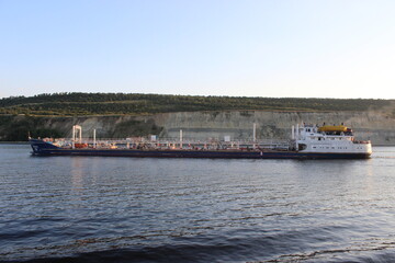 Fototapeta na wymiar The Volga River. A river oil tanker sailing along a steep bank.