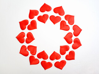 white background with red hearts in a circle shape with copy space in the center