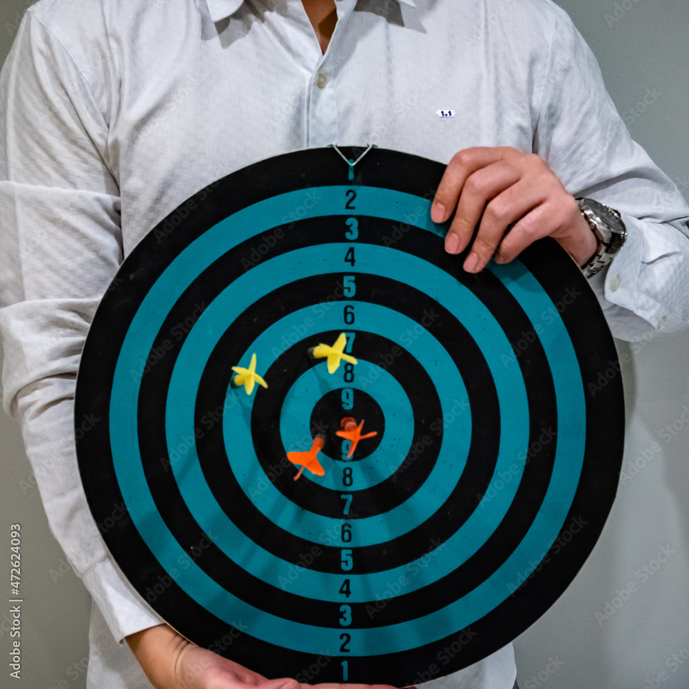 Aufkleber close up shot of the dart arrow hit on bulleyes of dartboard to represent that the business reached 