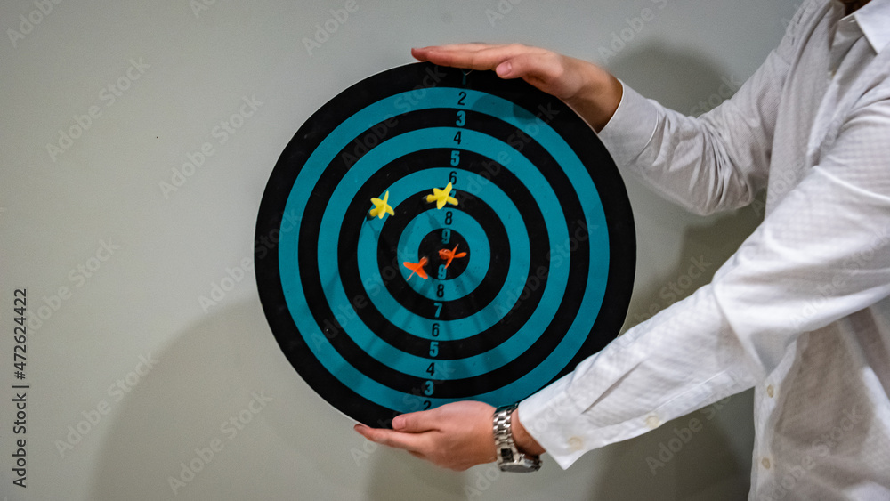 Poster bullseye is a target of business. dart is an opportunity and dartboard is the target and goal. so bo