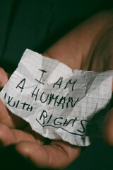 piece of paper that reads I am a human with rights