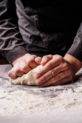 Fototapeta na wymiar pastry chef prepares yeast dough for pizza pasta.