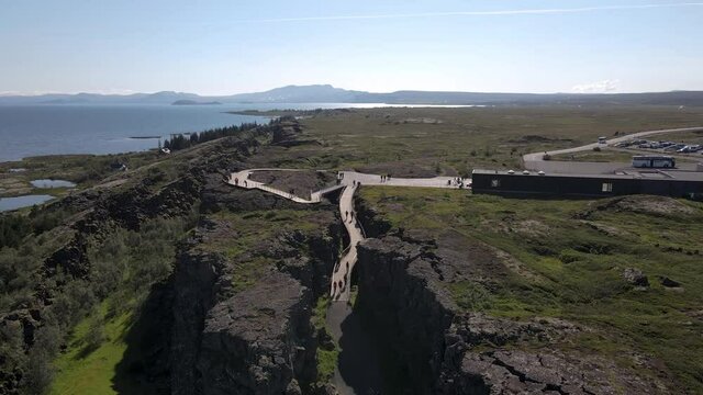 Cinematic aerial footage of Thingvellir national park, Iceland's parliament, the Thingvellir Church and the ruins of old stone shelters, hikes and lake in the golden circule