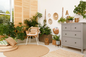 Room interior with stylish furniture and green plants