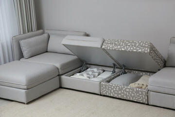 Modular sofa with storage near wall in living room. Interior design