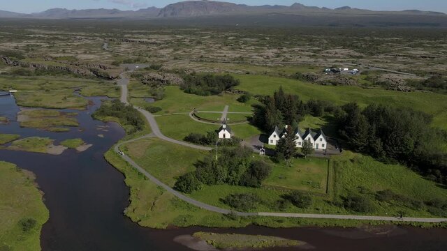Cinematic aerial footage of Thingvellir national park, Iceland's parliament, the Thingvellir Church and the ruins of old stone shelters, hikes and lake in the golden circule