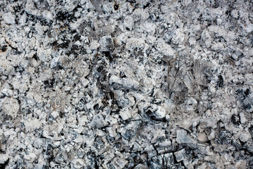 Ashes texture bacground. Wood ash in fireplace. Defocused charcoal cinder textured. Close up