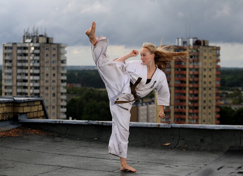A young karate girl on the roof in town