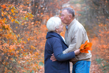 Elderly man kisses the woman's forehead