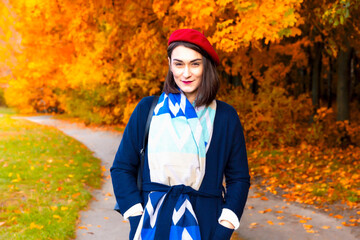 Young happy woman in autumn park