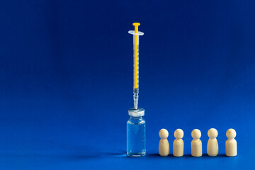 Mass vaccination concept. Wooden people standing in line to get vaccine.