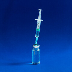 Covid-19 vaccines vials bottles with an injection syringe