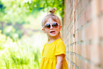 Funny little girl in yellow dress