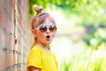 Funny little girl in yellow dress