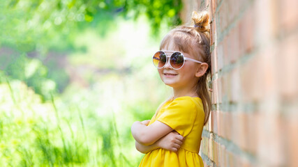 Happy girl in yellow summer dress