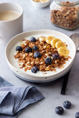 Granola with yogurt, blueberries, nuts, banana and honey. Muesli. Healthy eating. Vegetarian food.