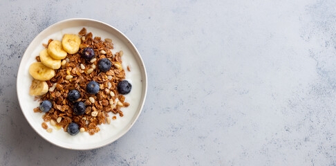 Granola with yogurt, blueberries, nuts, banana and honey. Muesli. Healthy eating. Vegetarian food.