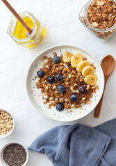 Granola with yogurt, blueberries, nuts, banana and honey. Muesli. Healthy eating. Vegetarian food.