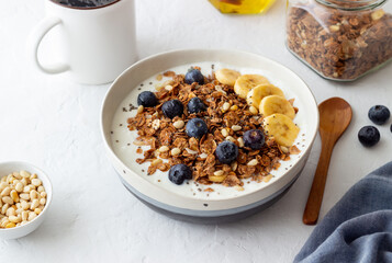 Granola with yogurt, blueberries, nuts, banana and honey. Muesli. Healthy eating. Vegetarian food.