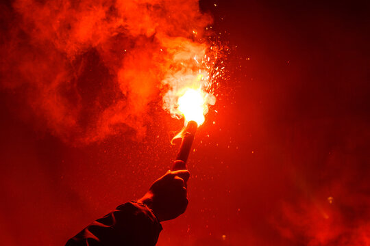 Burning red flare, flame, football hooligan