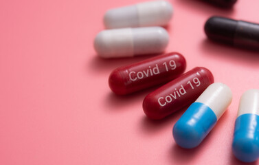 COVID-19 medicine, medicine for COVID-19, Capsule medicine, capsules pills,various capsule on a pink background