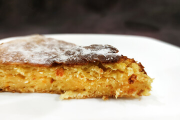 a slice of orange pie on a white plate close up