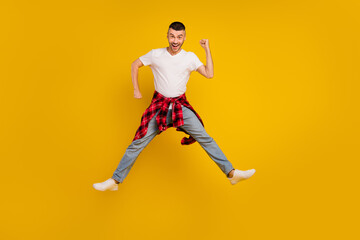 Fototapeta na wymiar Full length body size photo man jumping fooling playful isolated vivid yellow color background