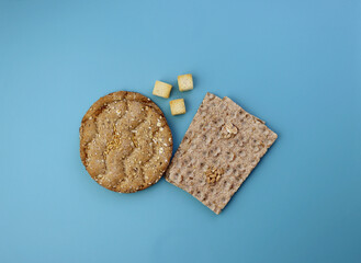 Two types of dry crispbread on a blue background. Multi-grain crispbread. 