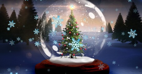 Composite image of decorated christmas tree in snow globe with snowflakes at sunset