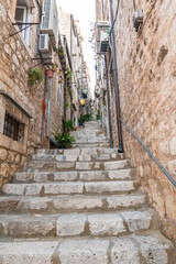 Fototapeta na wymiar Narrow street with stairs at old city of Dubrovnik, Croatia.