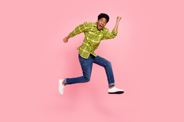 Fototapeta na wymiar Full size photo of millennial funky brunette guy run wear shirt jeans sneakers isolated on pink background