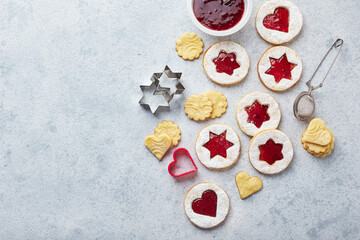 Classic Linzer Christmas Cookies with raspberry or strawberry jam on light background.