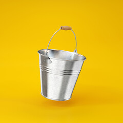 Silver iron bucket floating on a yellow background, 3d render