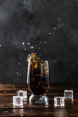 splashing sweet cola in a glass