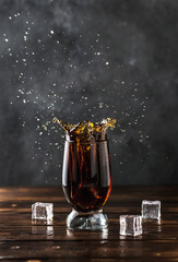splashing sweet cola in a glass